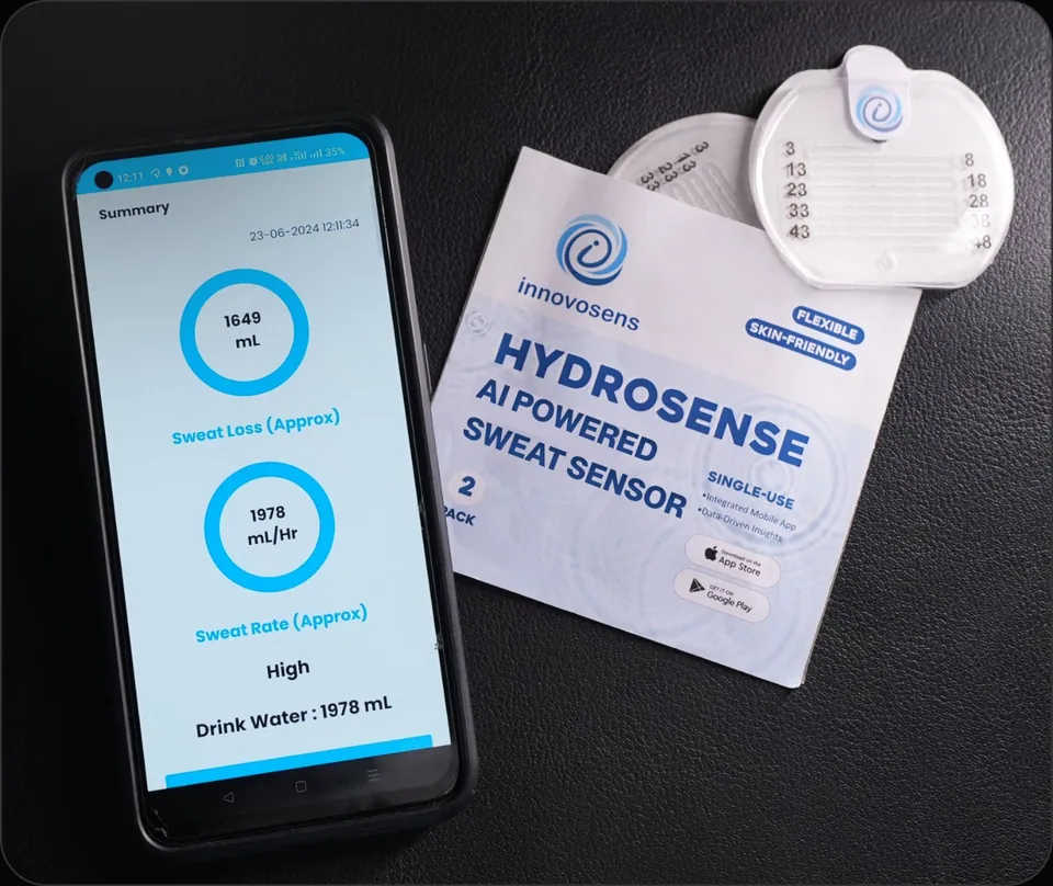 A phone showing the session summary next to a HydroSense two-pack and a sweat patch